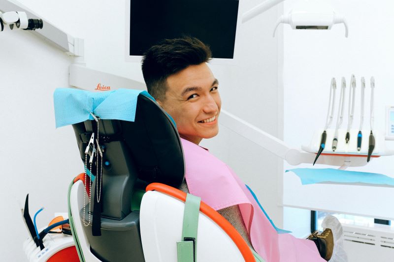 smiling man in dental chair at dental clinic in Wetherill Park
