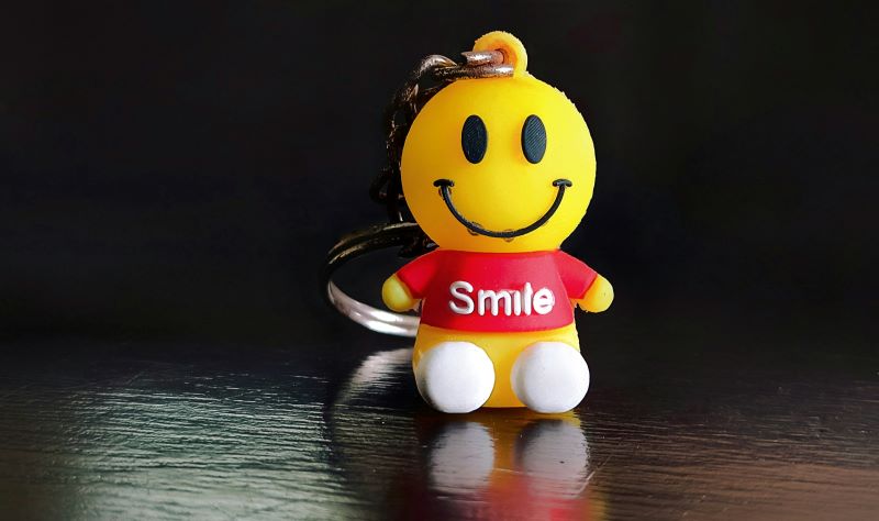 Cute smiley face keychain on t-shirt encouraging dental wellness in Wetherill Park