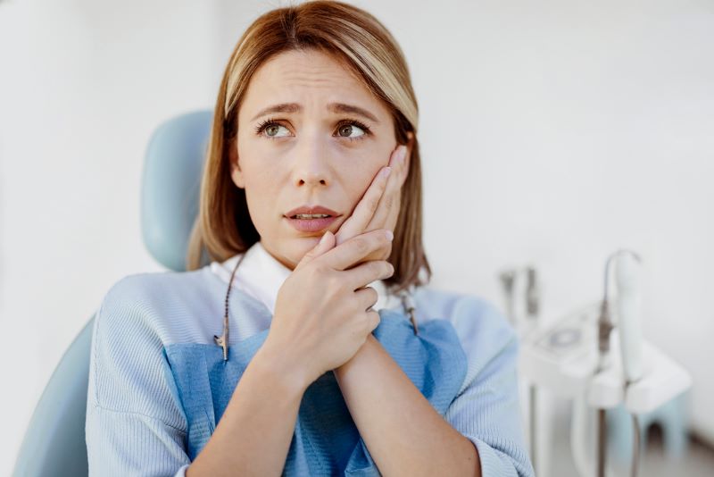 Woman with toothache at dental clinic in Wetherill Park