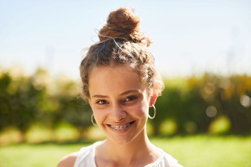 Teenager smiling with braces after orthodontic treatment in Wetherill Park