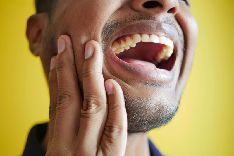 Wisdom tooth pain Wetherill Park patient holding jaw.