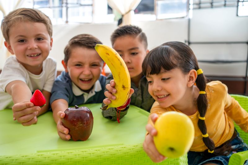 Children in Wetherill Park enjoying healthy snacks like fruits to support dental health