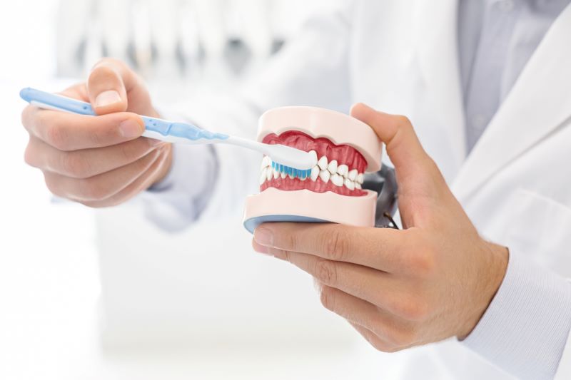 Dentist in Wetherill Park showing brushing technique to prevent sensitive teeth