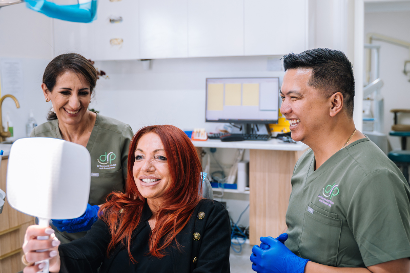Dr Raymond Platon and Nurse Nora with a patient during a dental visit in Wetherill Park.