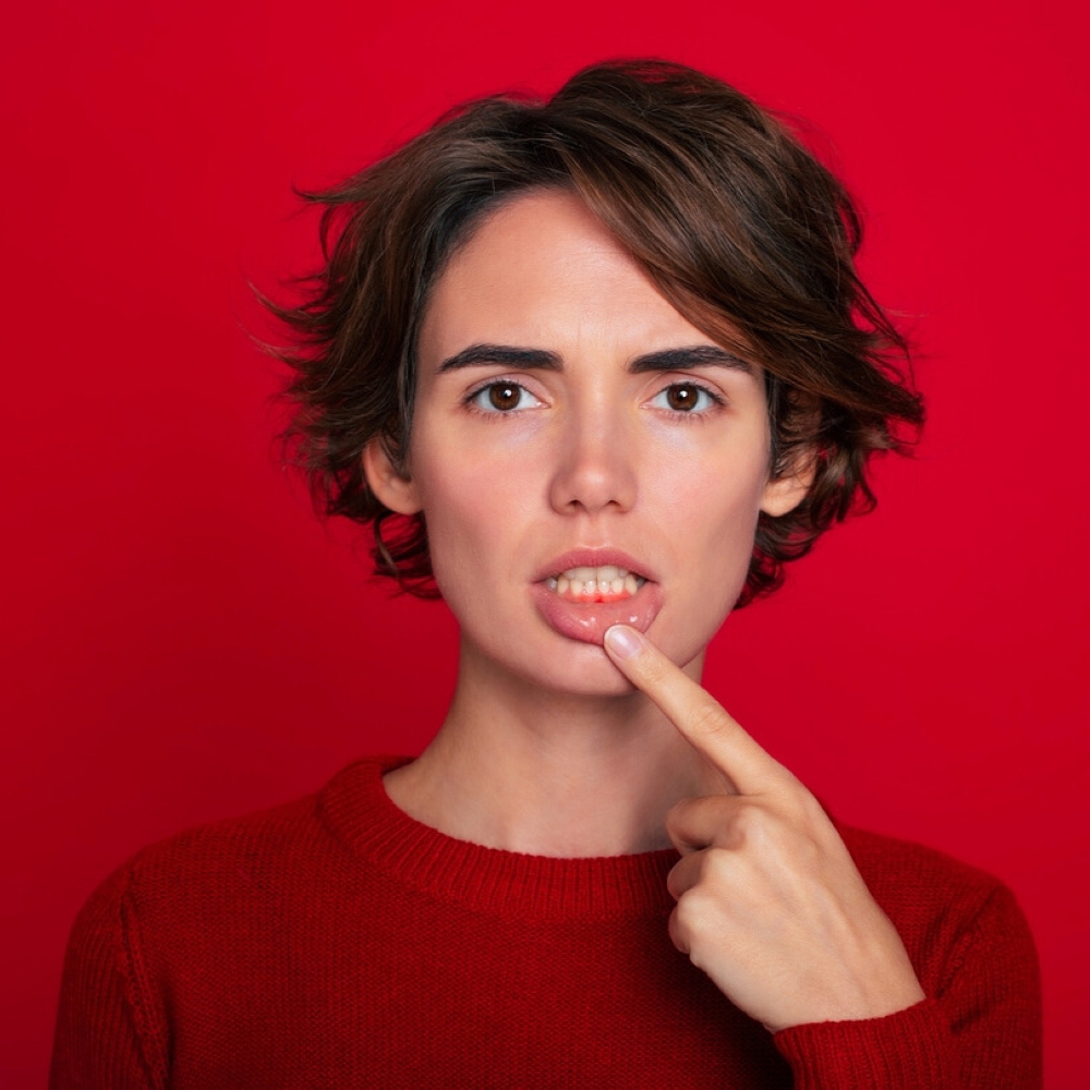 service-gum-disease-dentist-wetherill-park Woman pointing to gums – Gum Disease Treatment Wetherill Park.