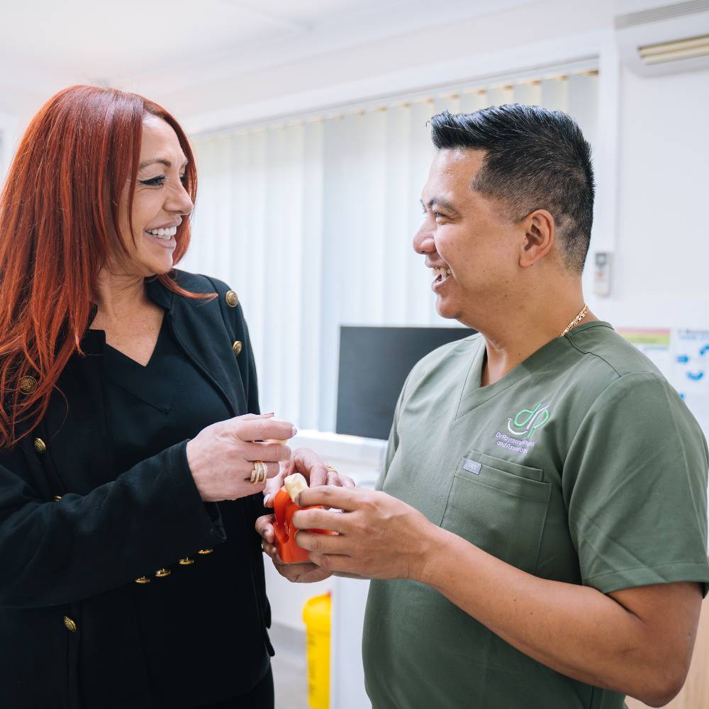 Dr Raymond Platon discussing treatment options with a new patient at his dental clinic in Wetherill Park