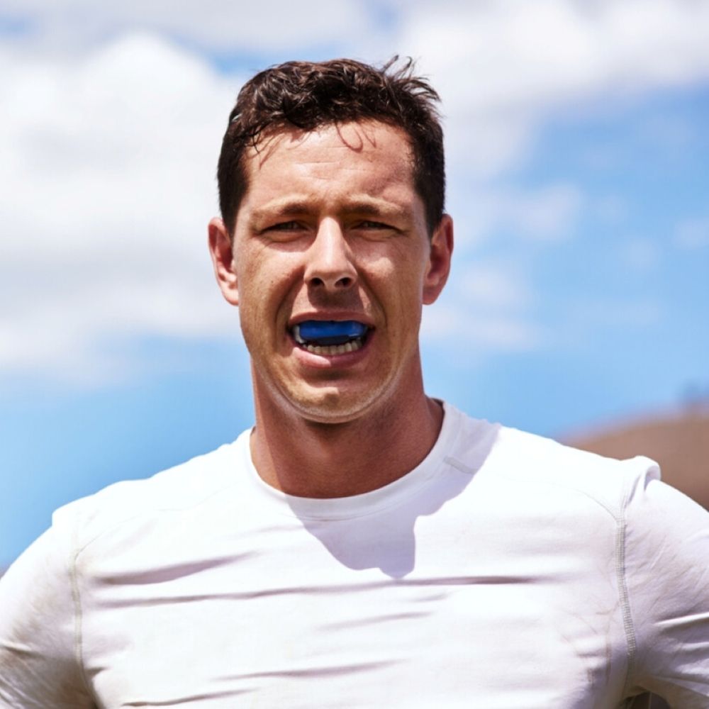 Athlete wearing a blue custom sports mouthguard at Dr Raymond Platon & Associates in Wetherill Park.