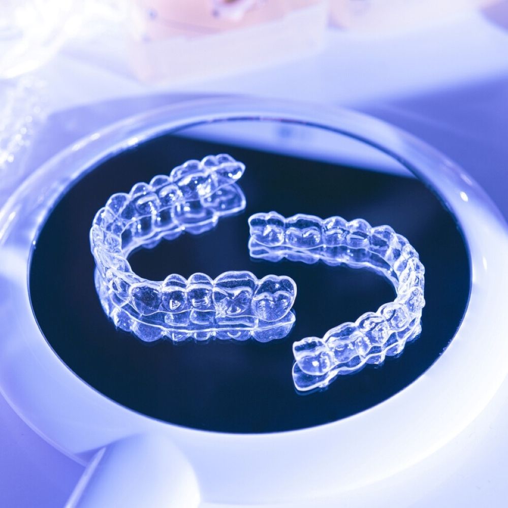 Clear Invisalign® aligners on a dental mirror – orthodontic treatment in Wetherill Park.