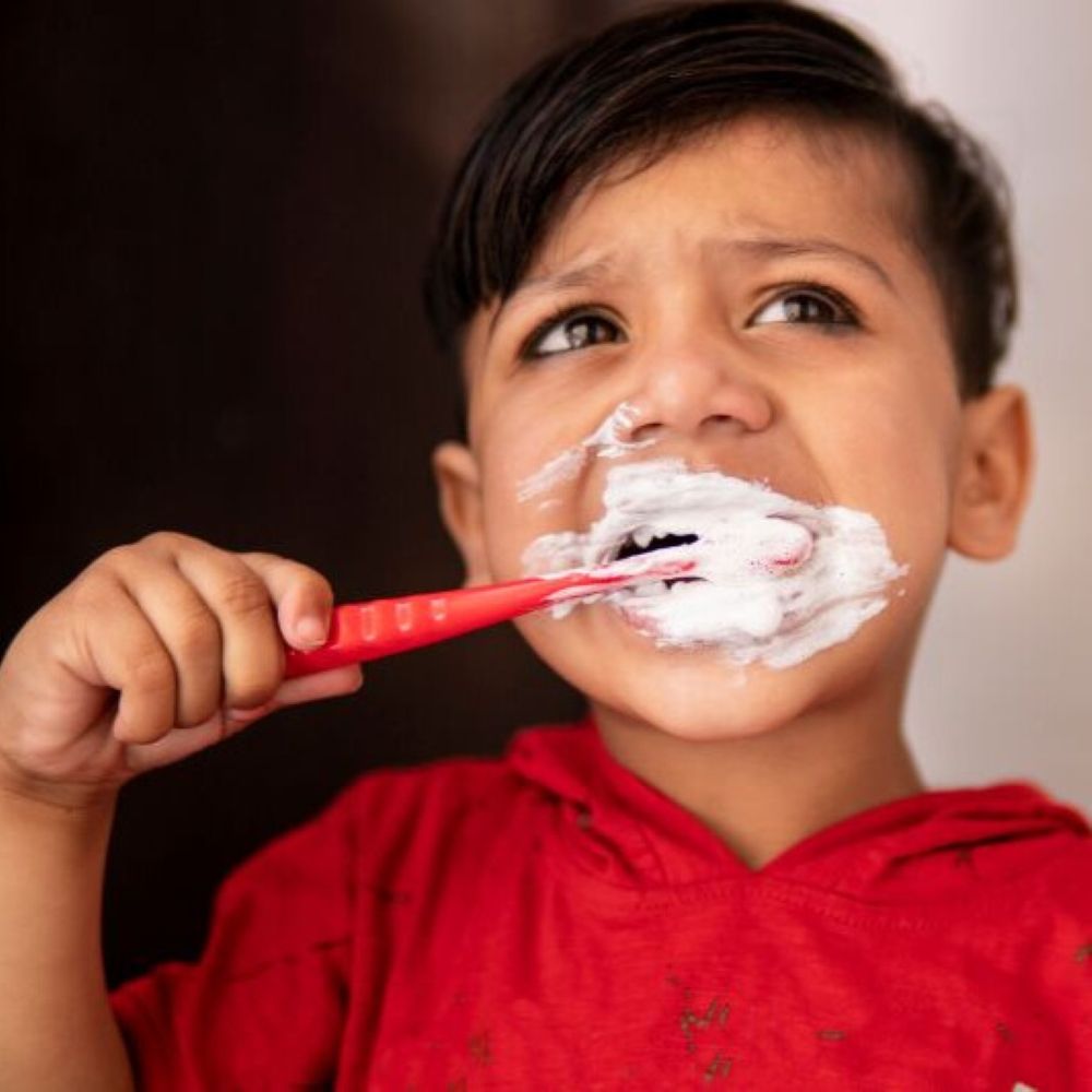 Kids professional teeth cleaning Wetherill Park - child brushing teeth with toothpaste foam.