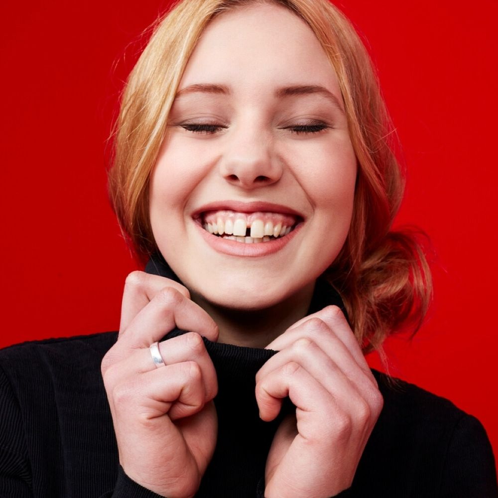 Young woman smiling with visible tooth gap – tooth gap filling consultation in Wetherill Park.