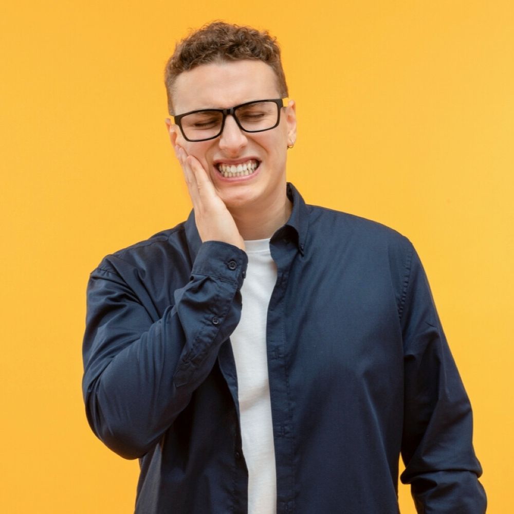 Man holding his jaw in pain – wisdom teeth removal Wetherill Park.