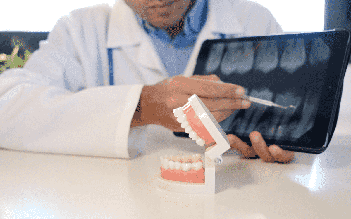 Dentist explaining causes of food stuck between teeth during dental consultation in Wetherill Park