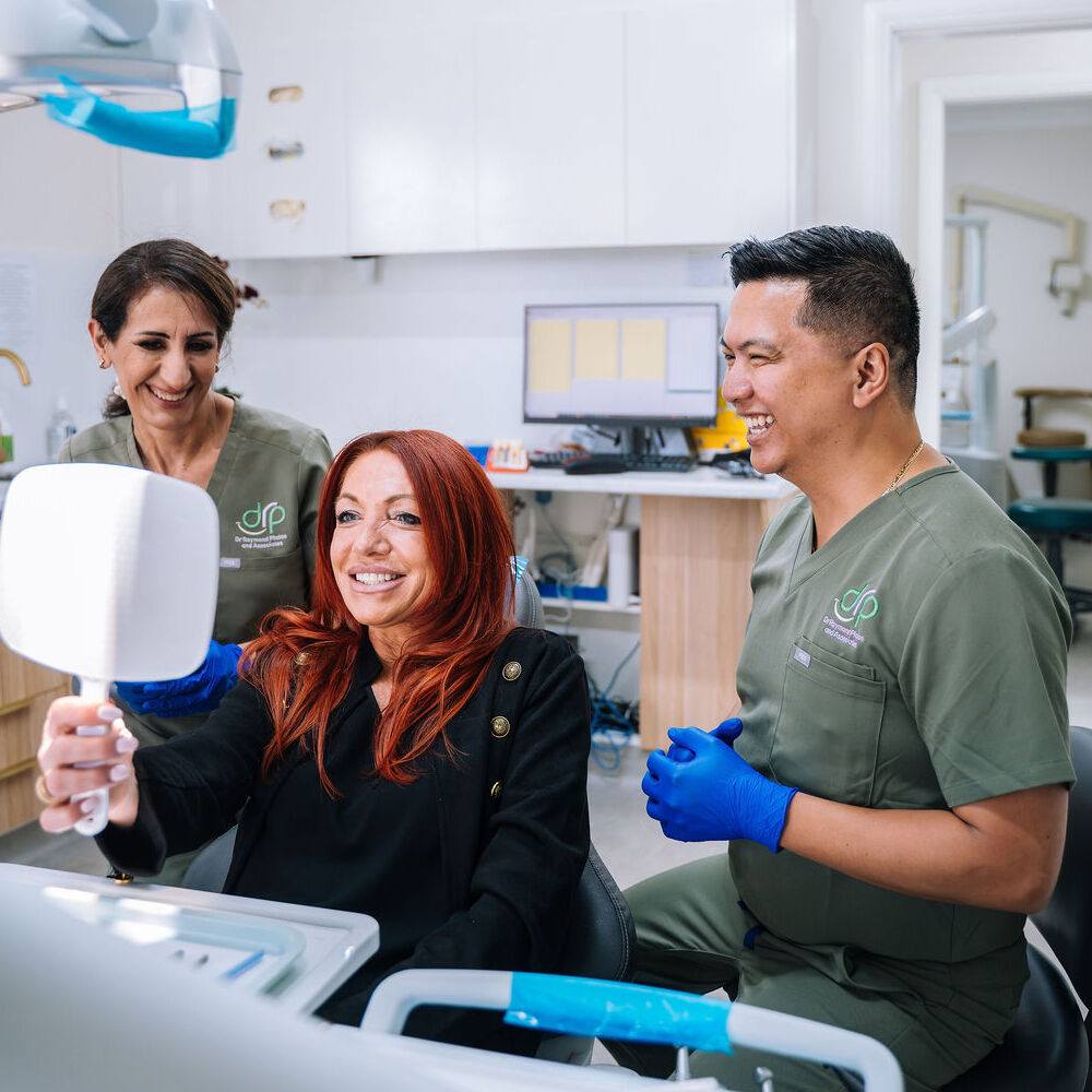 Patient reviewing smile with dentist after porcelain veneers consultation in Wetherill Park