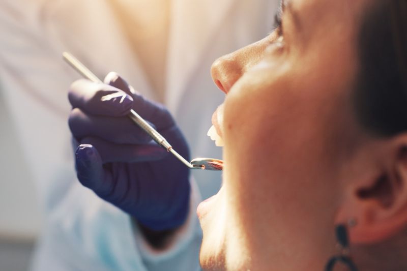 Dentist examining sensitive tooth after filling treatment in Wetherill Park