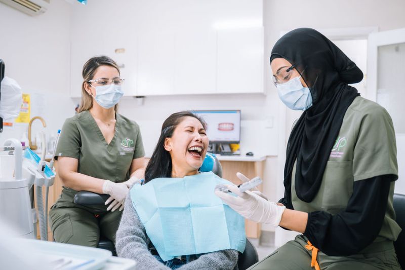 Dr Loreen discussing healthy smile care with patient in Wetherill Park