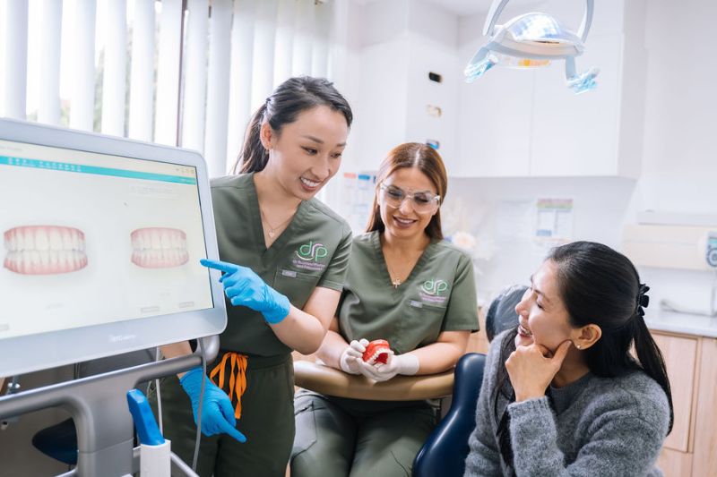 Oral health therapist Caroline explaining dental treatment to patient in Wetherill Park clinic