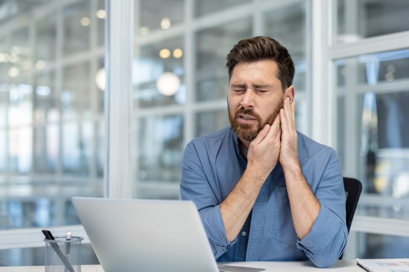 Professional experiencing jaw pain from stress while working in Wetherill Park
