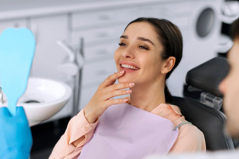 Patient reviewing her smile with a dentist after professional teeth whitening consultation in Wetherill Park.