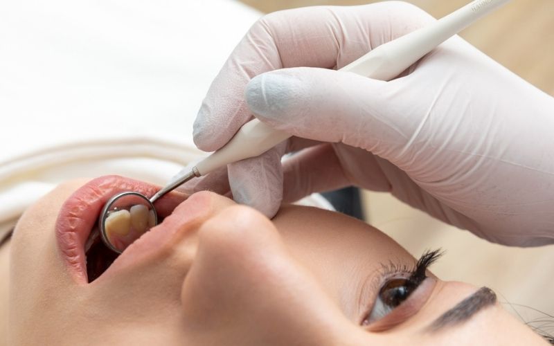 Dentist examining a patient's tooth during a dental assessment in Wetherill Park